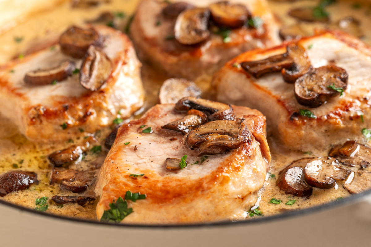 Thick boneless pork chops with browned mushrooms and fresh parsley in a creamy sage pan sauce. Seared pork chops topped with roasted baby portobello mushrooms in fresh sage cream sauce