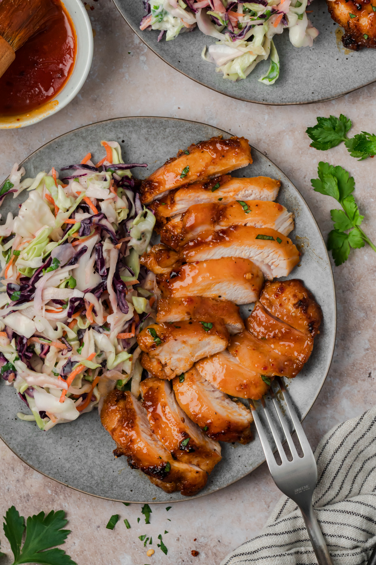 Sliced roasted chicken thighs with homemade hot honey glaze served with creamy coleslaw.
