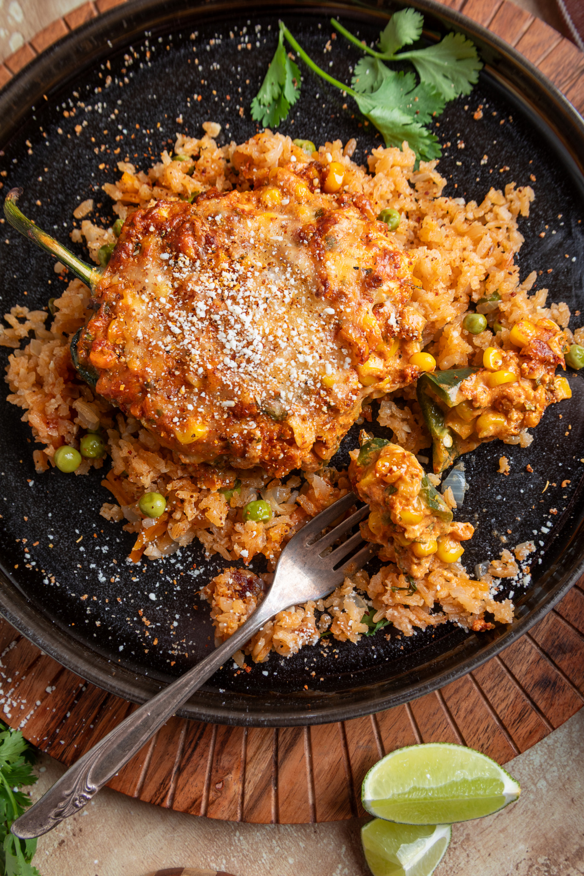 Cheesy chorizo and corn stuffed poblano pepper topped with Cotija and Taj&iacute;n and served over Mexican rice