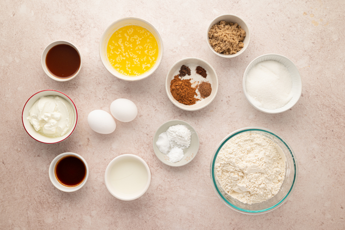 Ingredients for apple cider streusel muffins with reduced apple cider, cinnamon, nutmeg, allspice and cloves. Ingredients for apple cider streusel muffins including reduced cider, flour, sugars, buttermilk, eggs, butter and spices.