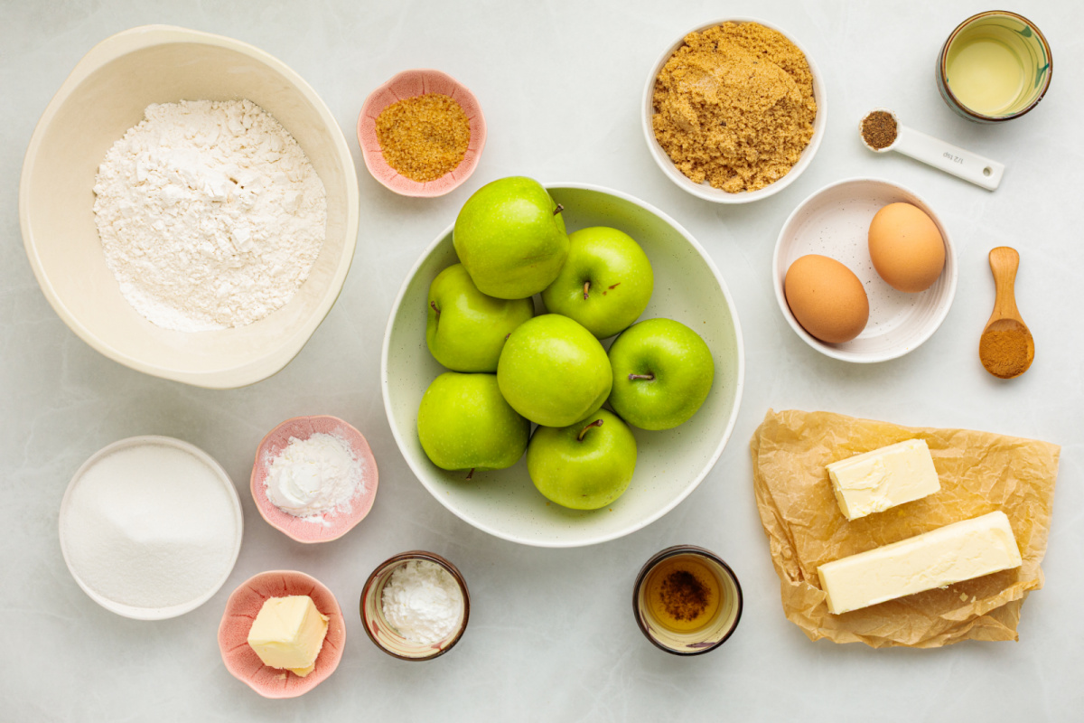 Ingredients for the cinnamon apple filling and soft butter cake topping. Granny Smith apples, flour, butter, sugars, eggs, cinnamon and other ingredients for apple cobbler with cake topping.