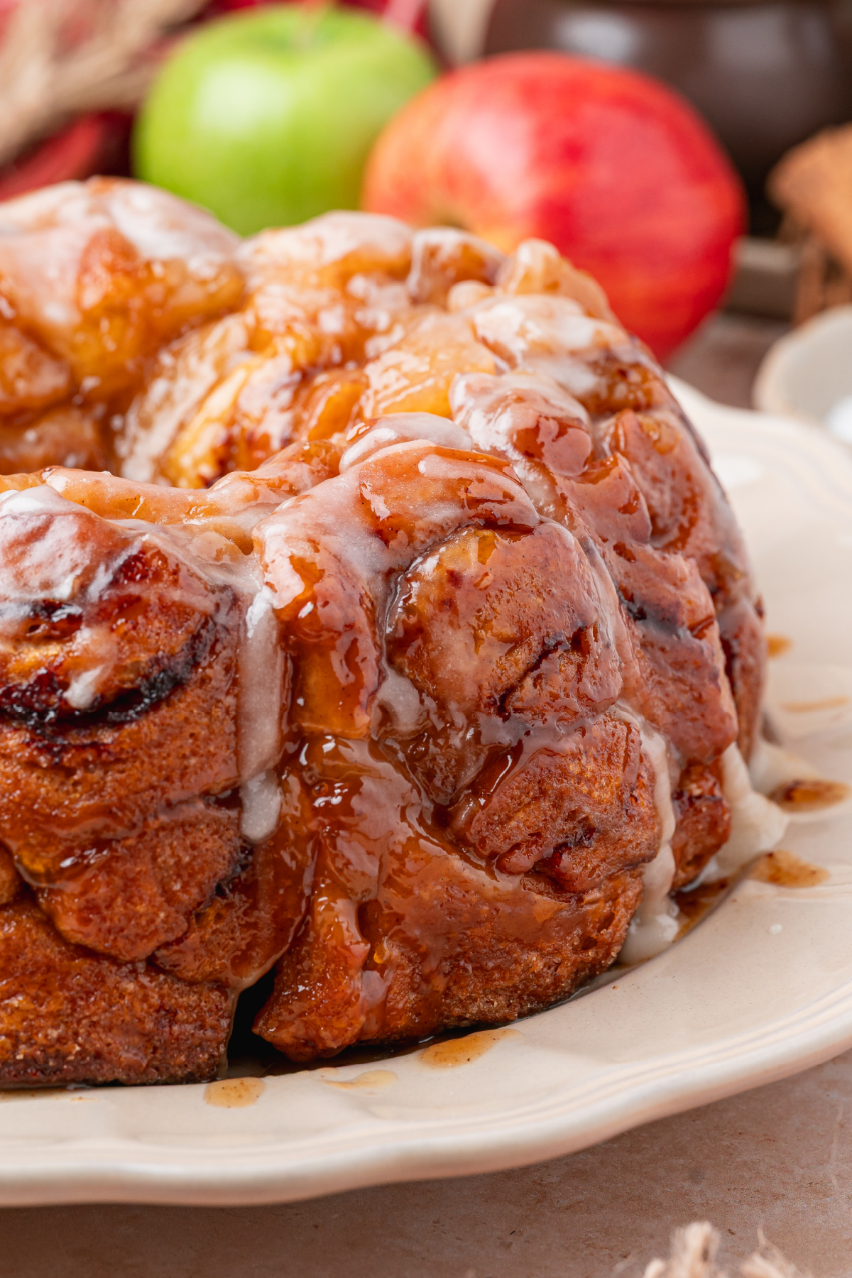 Apple pie cinnamon roll monkey bread with caramelized brown sugar sauce and cinnamon roll icing.