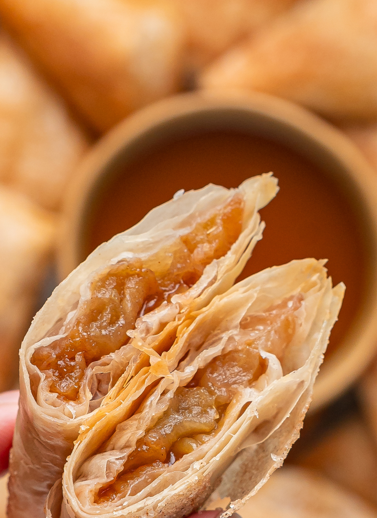 Apple Filling Inside Apple Pie Samosas Apple pie samosa broken open to show the spiced Granny Smith apple filling inside crisp layers of phyllo dough.