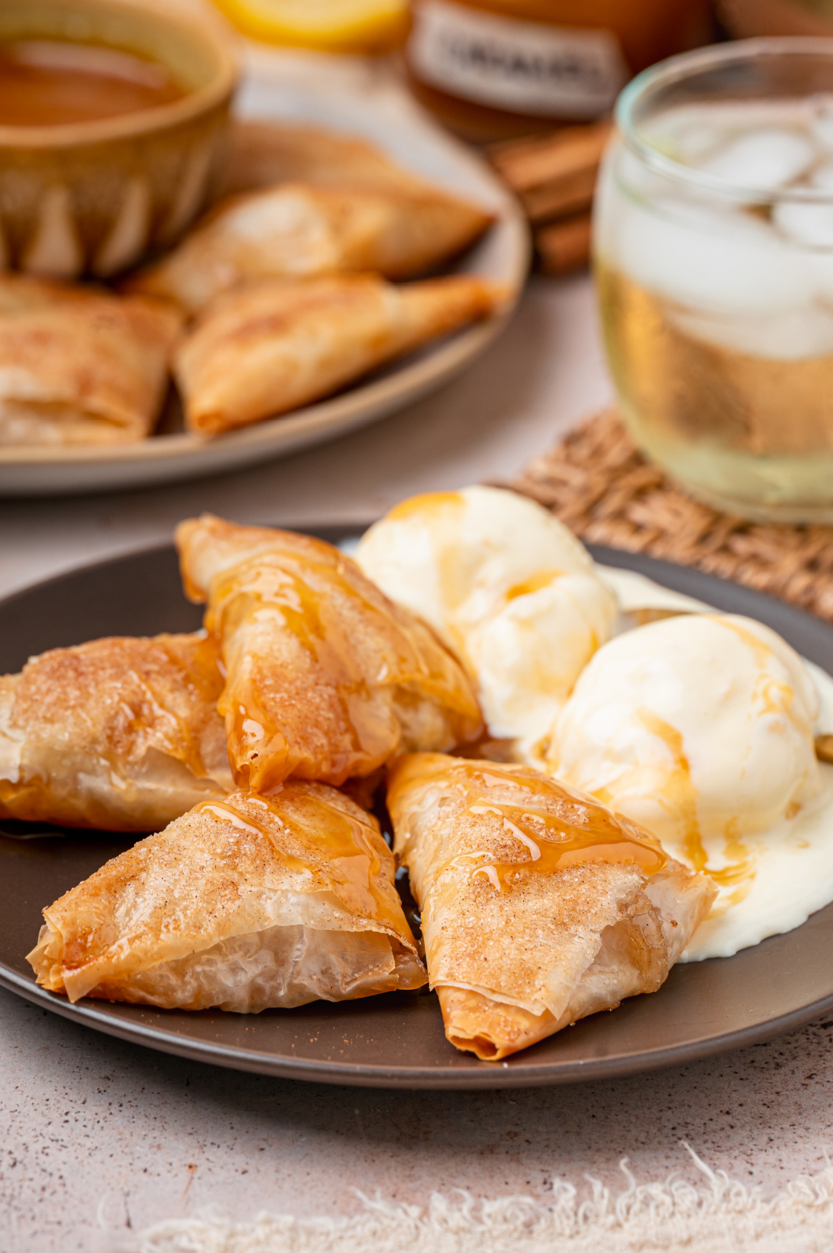 Warm Apple Pie Samosas with Vanilla Ice Cream Warm apple pie samosas drizzled with caramel sauce and served with vanilla ice cream.
