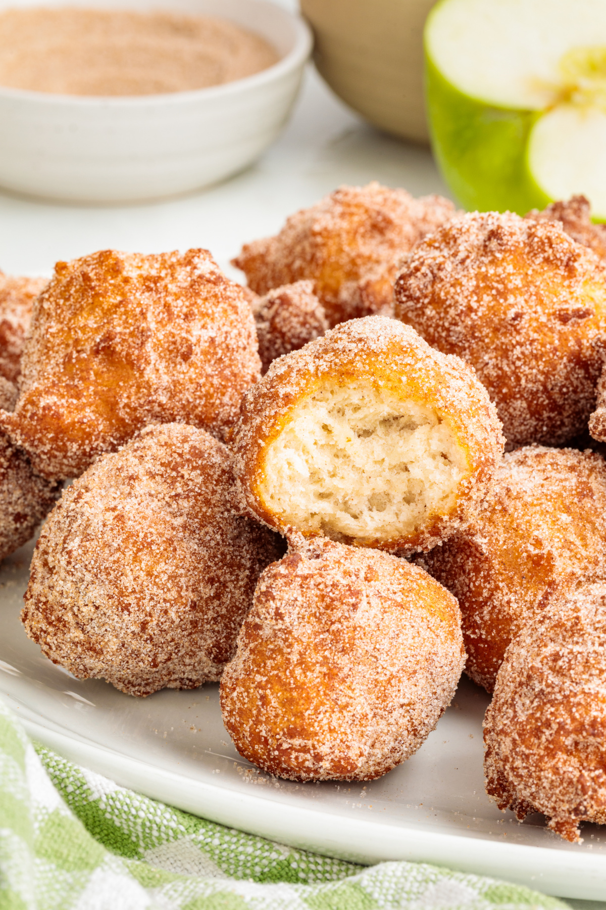 Inside of a cinnamon sugar applesauce fritter after frying Applesauce fritter broken open to show the soft cooked center