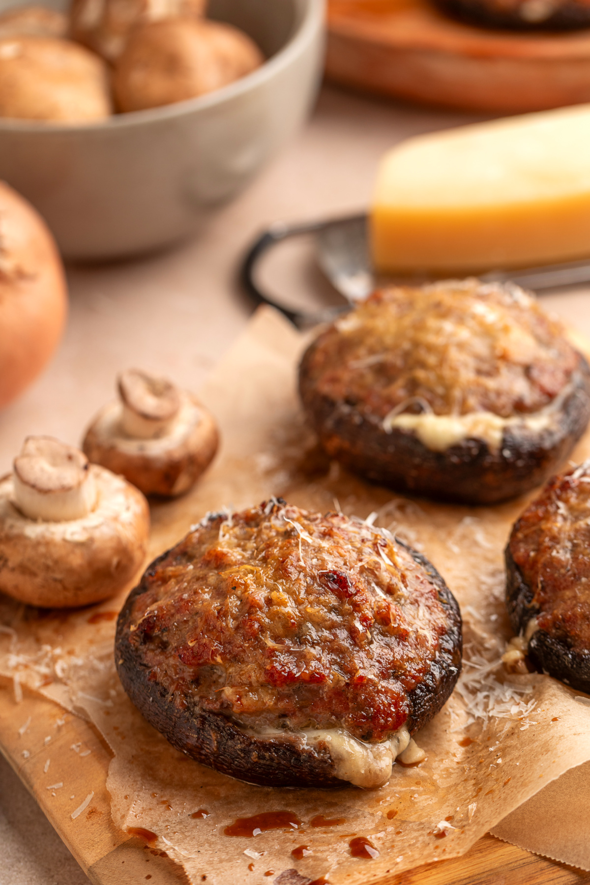 Grilled portobellos filled with sweet Italian sausage, Parmesan and mozzarella, with whole mushrooms and cheese alongside. Grilled portobello mushroom filled with sweet Italian sausage, mozzarella and Parmesan