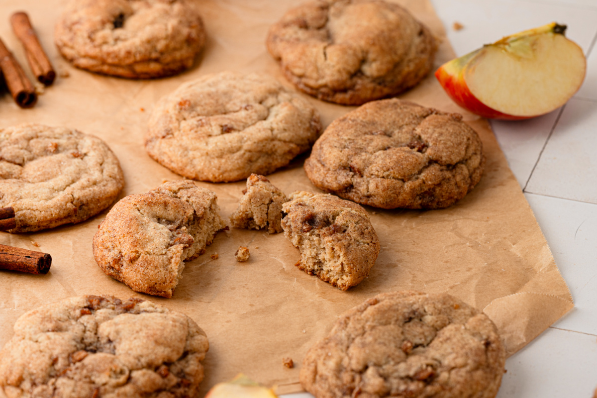 Cinnamon apple cookies broken open to show their soft centers and cooked apple pieces