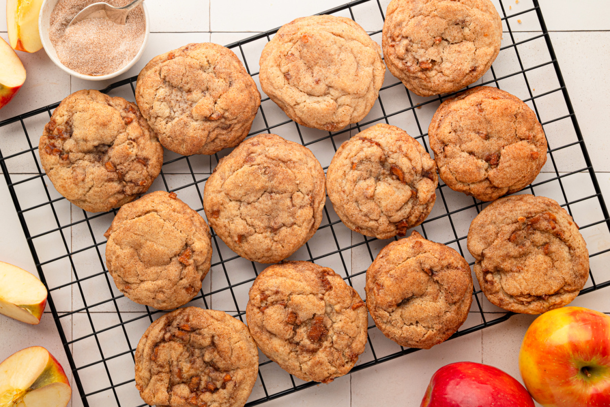 Cinnamon apple snickerdoodle cookies with cooked apple pieces cooling on a wire rack