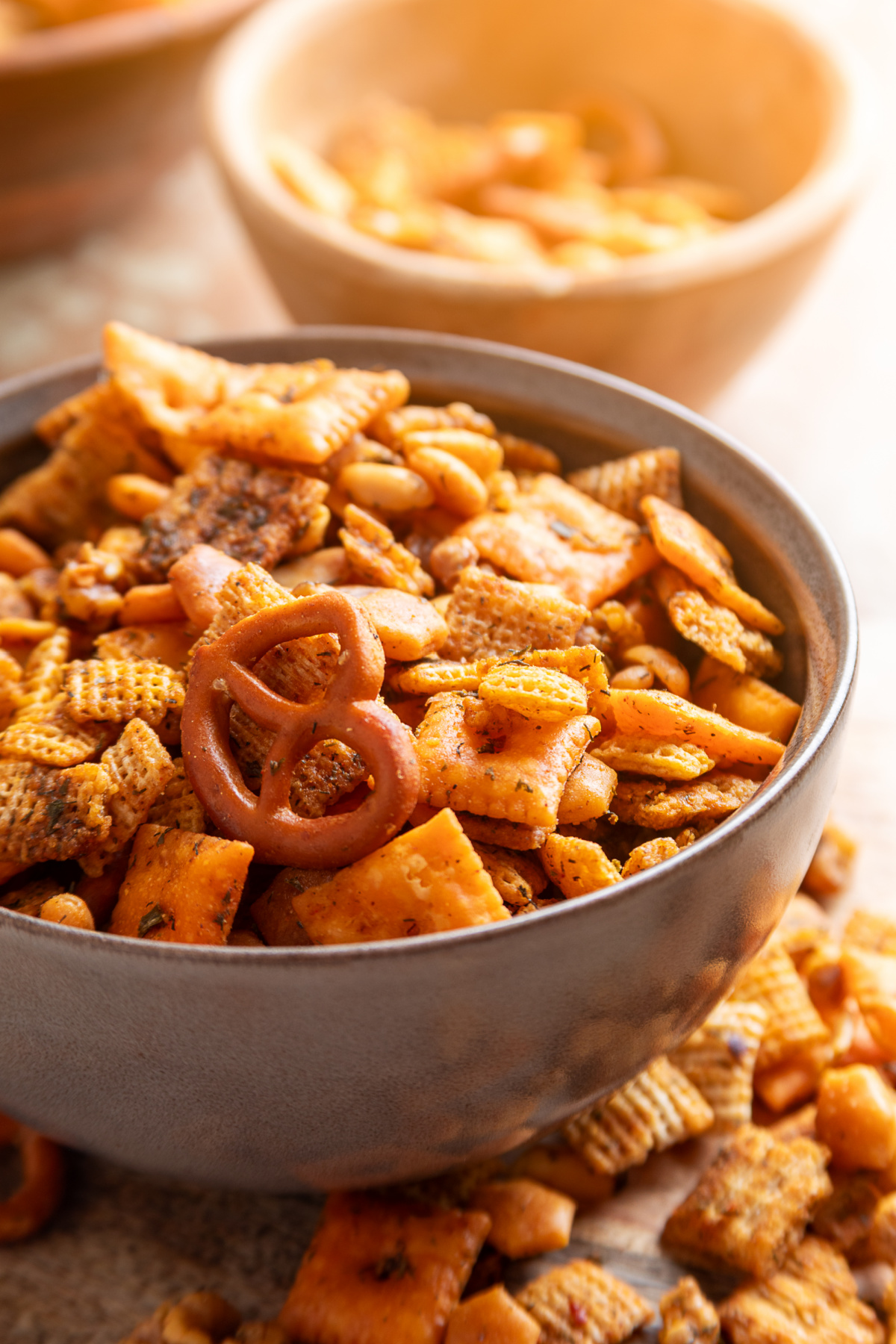 Cowboy butter snack mix with Chex cereal, Cheez-It crackers, pretzels, Triscuits, peanuts and walnuts in a serving bowl