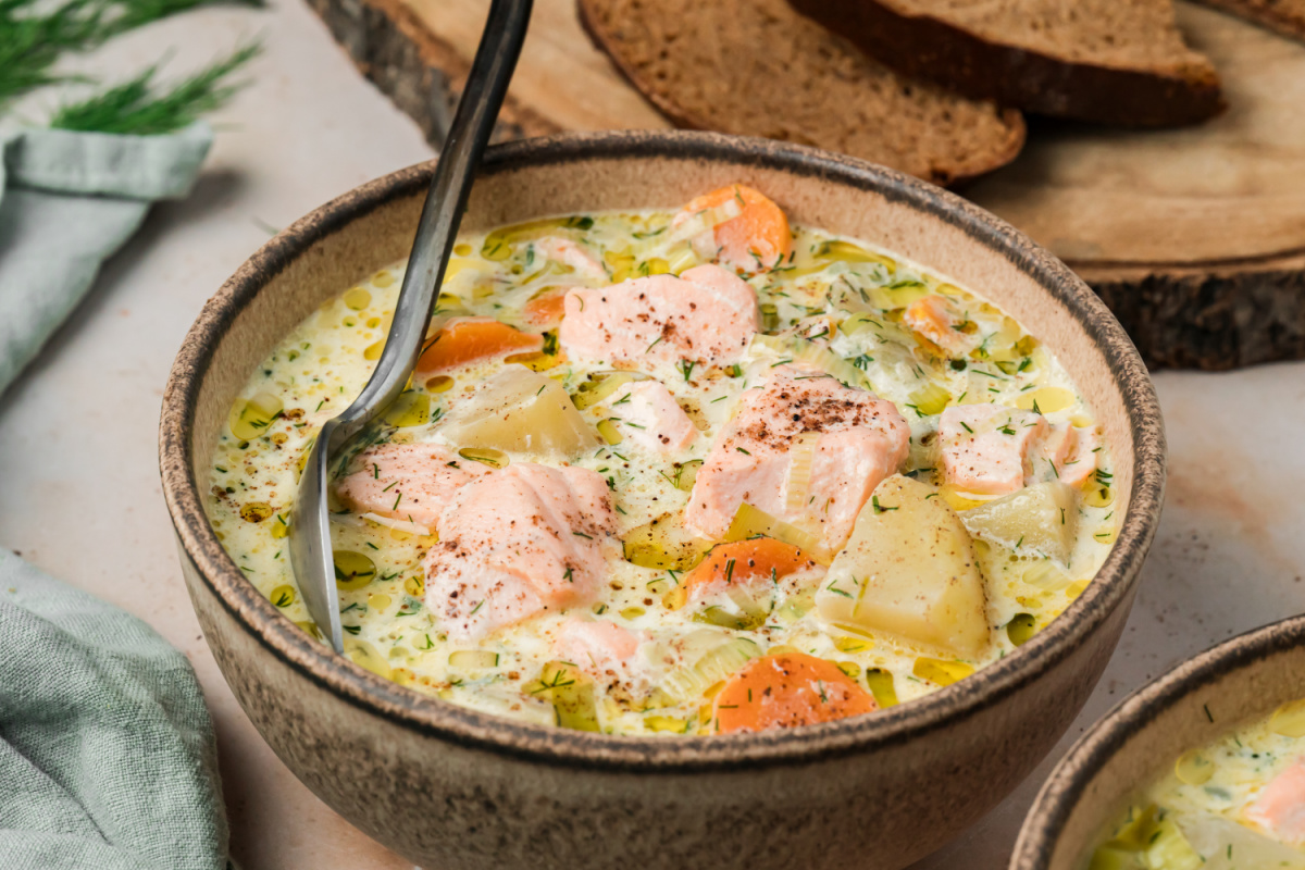 Bowl of Finnish salmon soup with salmon, Yukon Gold potatoes, carrots, leeks and fresh dill in creamy broth.