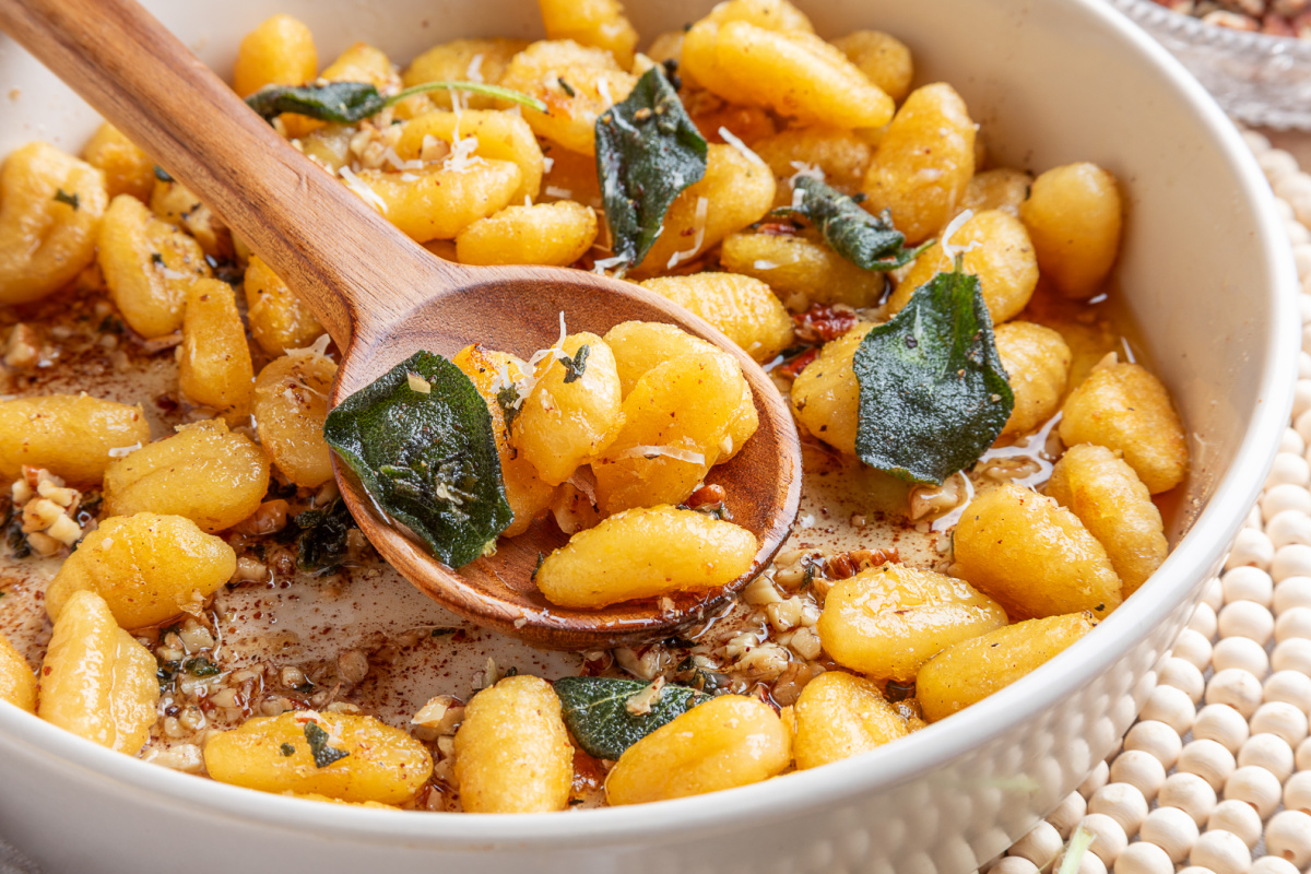 Crispy potato gnocchi spooned with brown butter, toasted nuts and fried sage. Crispy gnocchi with sage brown butter served with fried sage leaves, toasted nuts and Parmesan.