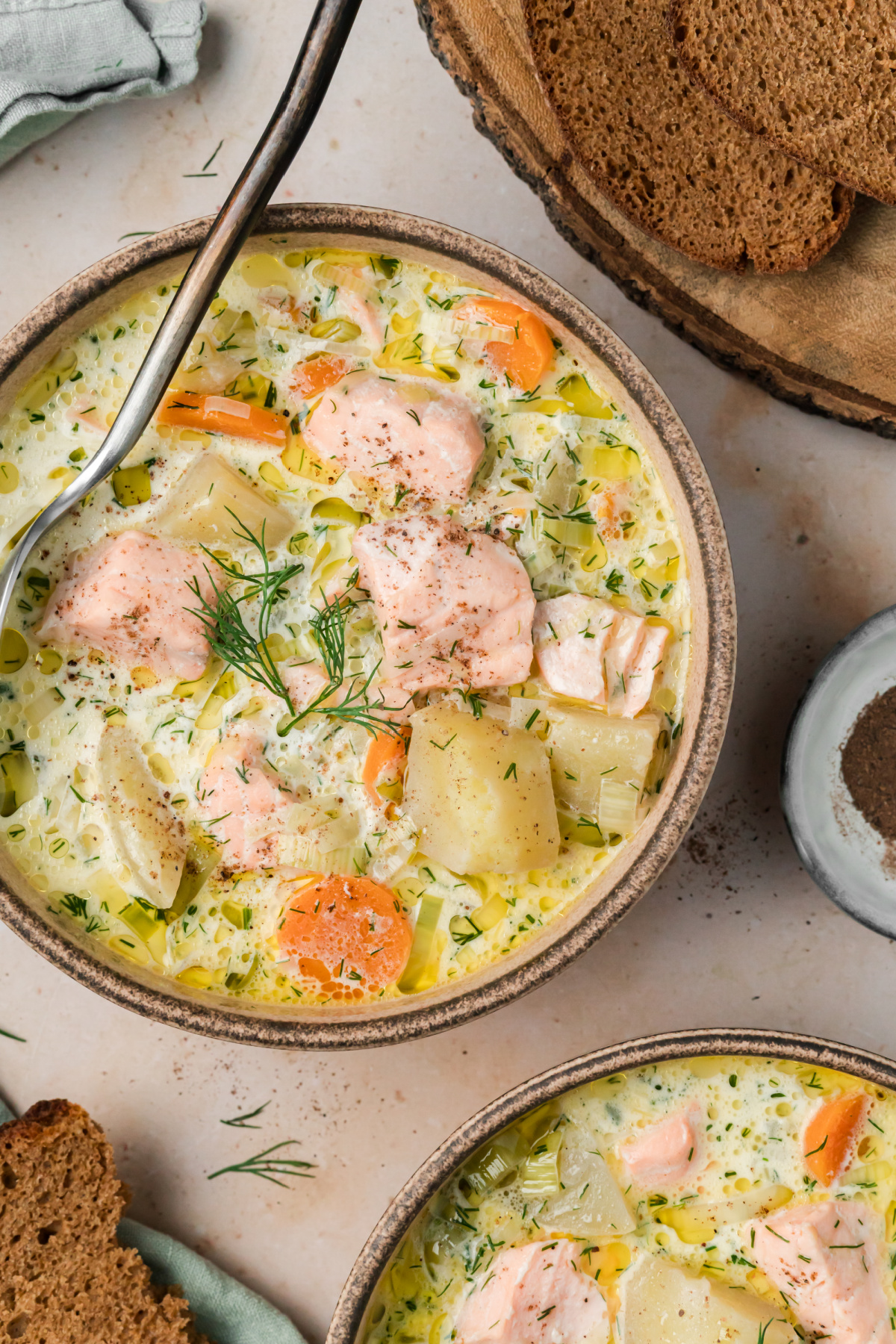 Bowl of Finnish salmon soup with salmon, potatoes, carrots, leeks and fresh dill in a creamy broth.