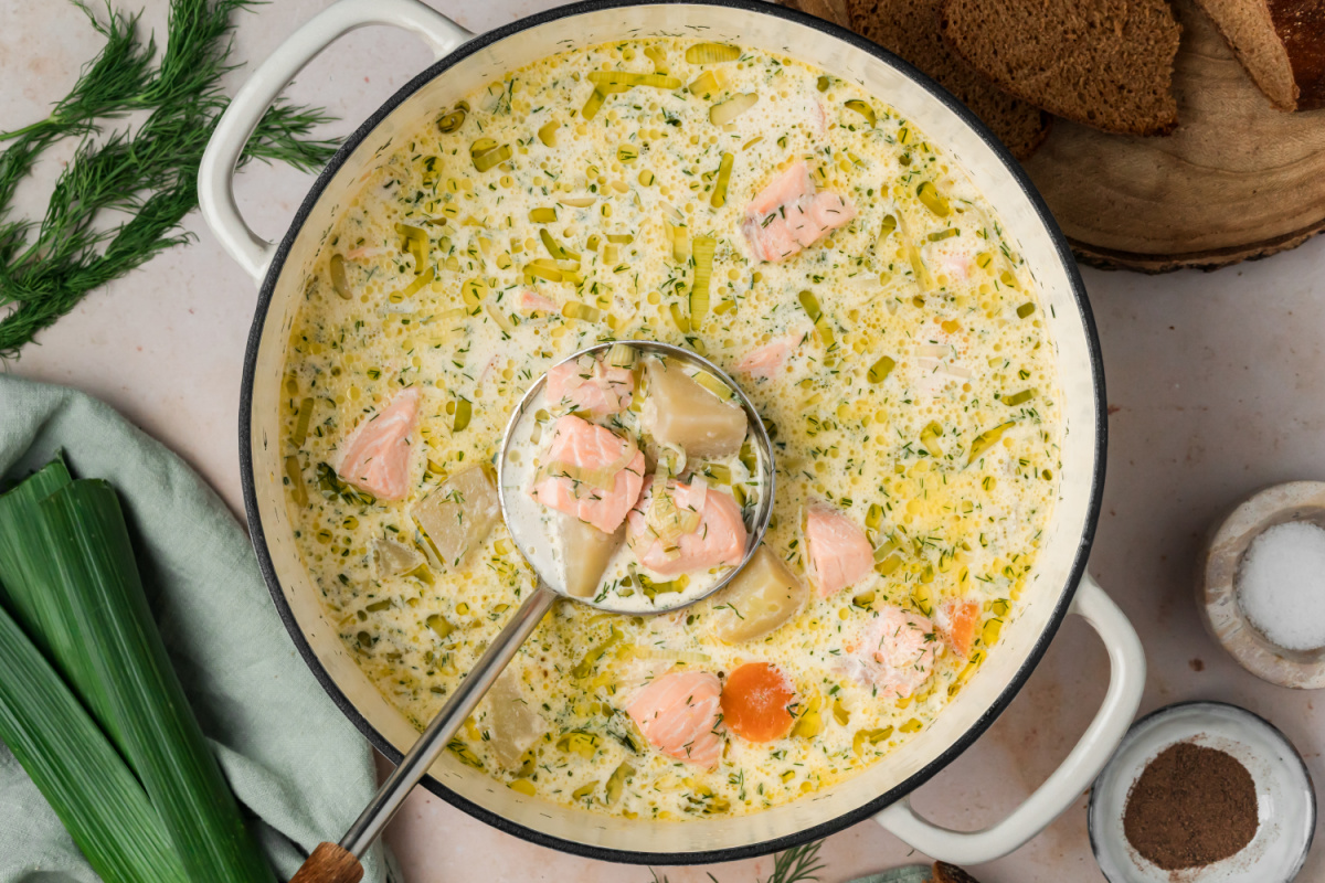 Overhead view of Finnish salmon soup with salmon, potatoes, leeks, carrots and dill in a creamy fish broth.