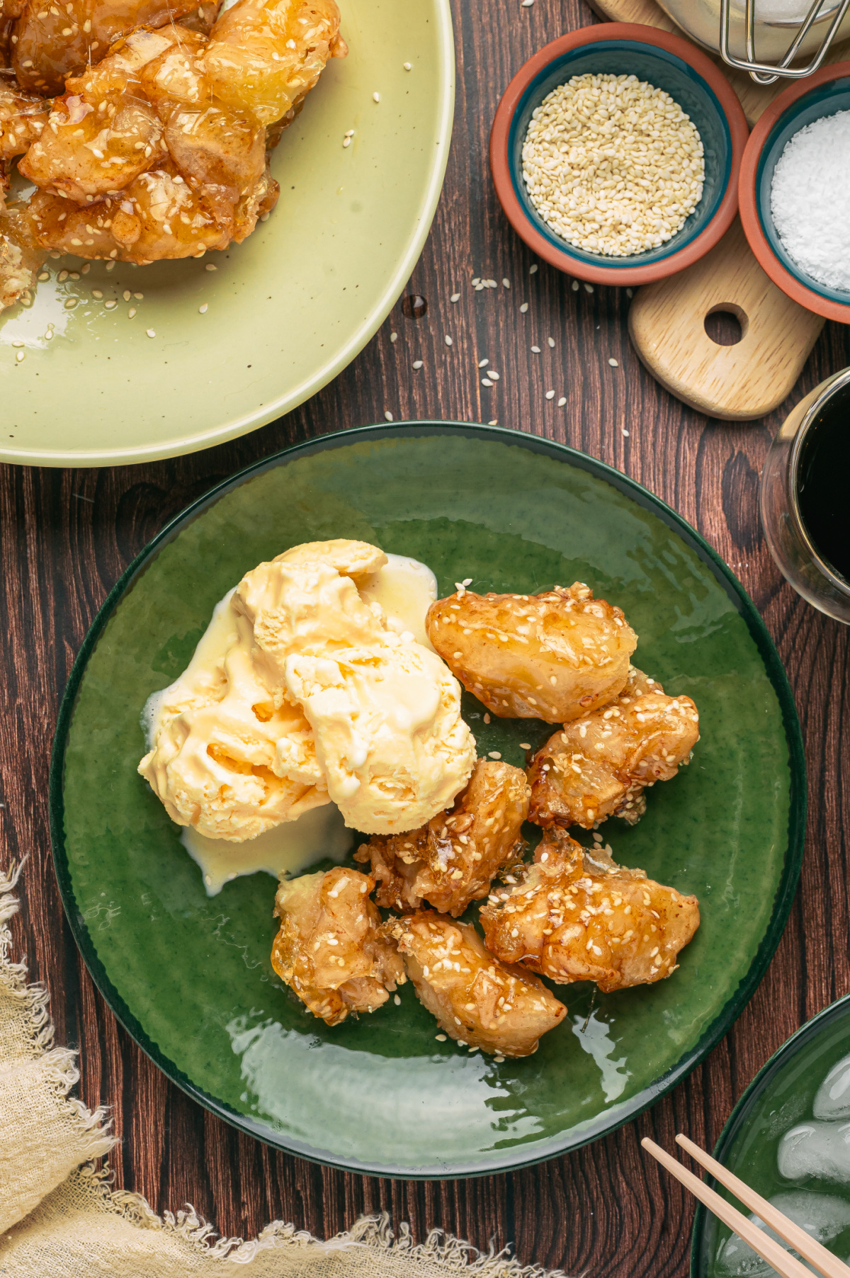 Caramel-Coated Fried Apples with Vanilla Ice Cream Sesame caramel-coated fried apples served with scoops of vanilla ice cream