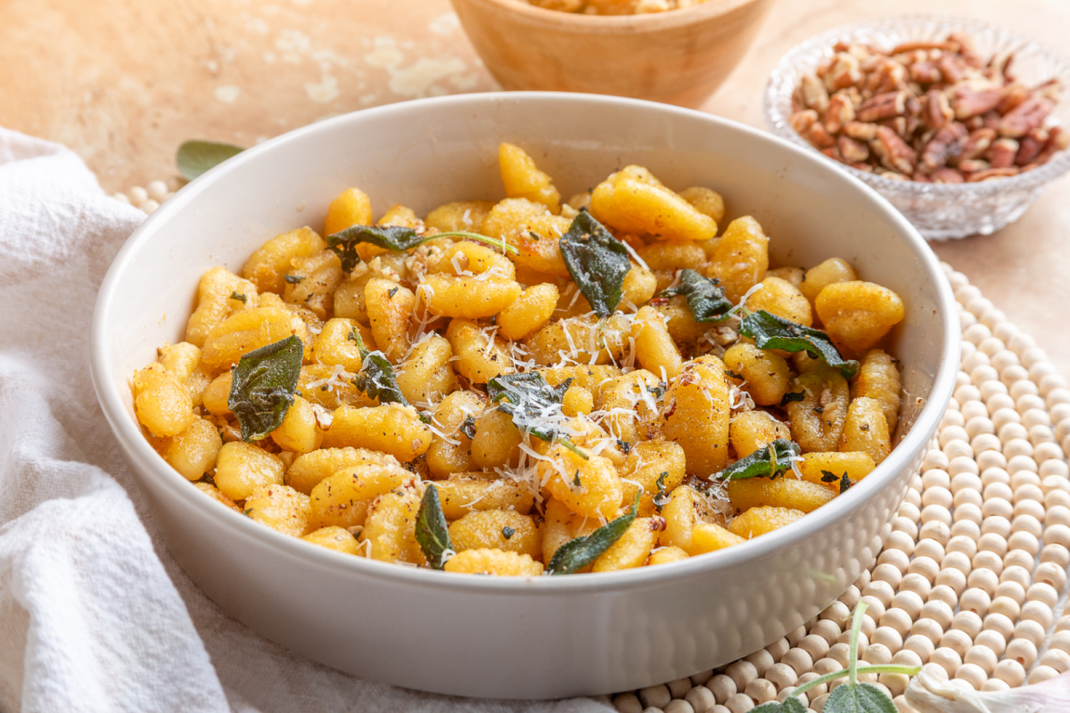 Golden pan-fried gnocchi finished with sage brown butter and Parmesan. Pan-fried potato gnocchi with Parmesan, fried sage leaves and toasted walnuts and pecans.