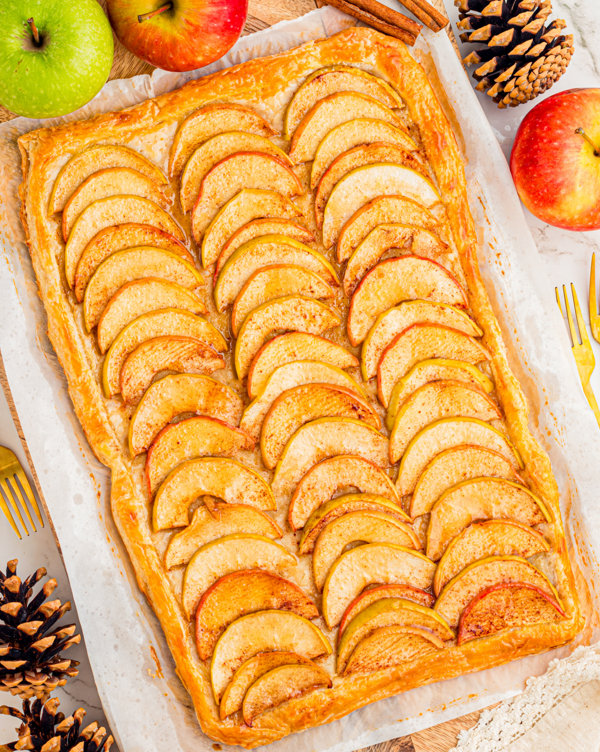 Freshly baked puff pastry apple tart made with Granny Smith and Dazzle apples Puff pastry apple tart with thinly sliced apples, cinnamon and a golden pastry border