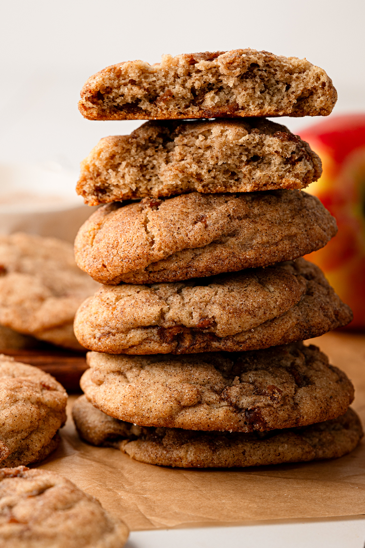 Soft cinnamon apple cookies cut open to show the chewy interior and cooked apple pieces