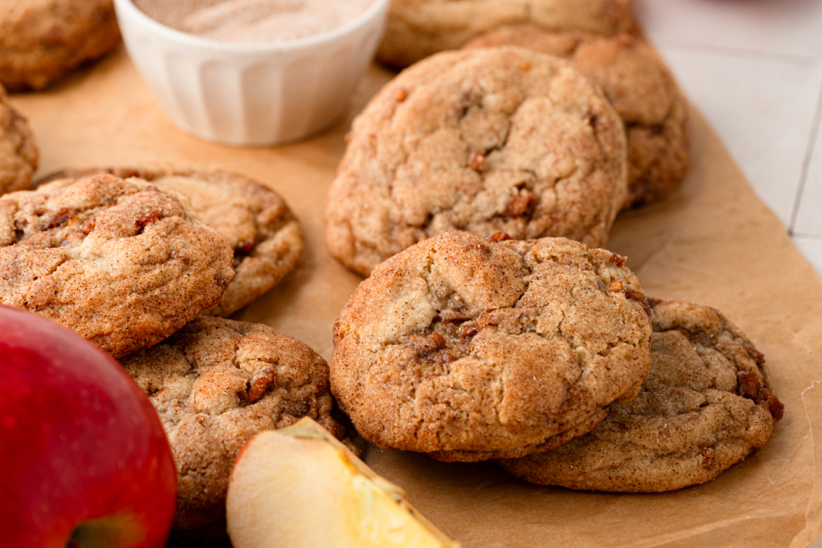 Thick cinnamon apple cookies with visible pieces of cooked Honeycrisp apple