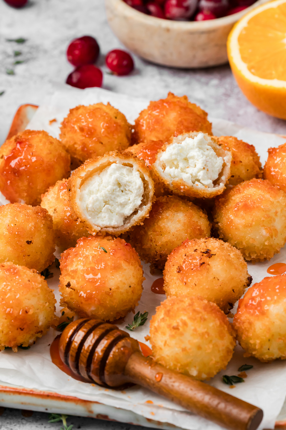 Fried Goat Cheese Balls with Cranberry Hot Honey Fried goat cheese balls with crispy panko coating, creamy goat cheese centers, and cranberry hot honey drizzled over the top.