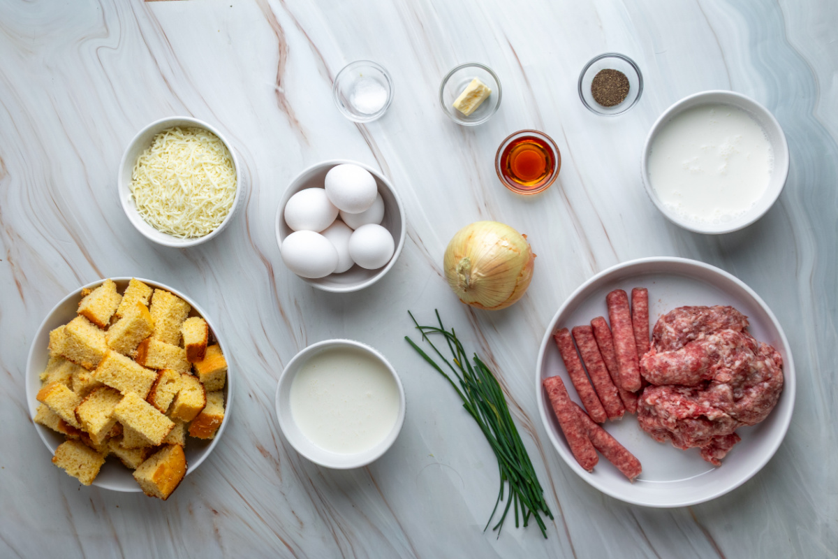 Ingredients for leftover cornbread breakfast casserole with two kinds of sausage, eggs, cheese and chives