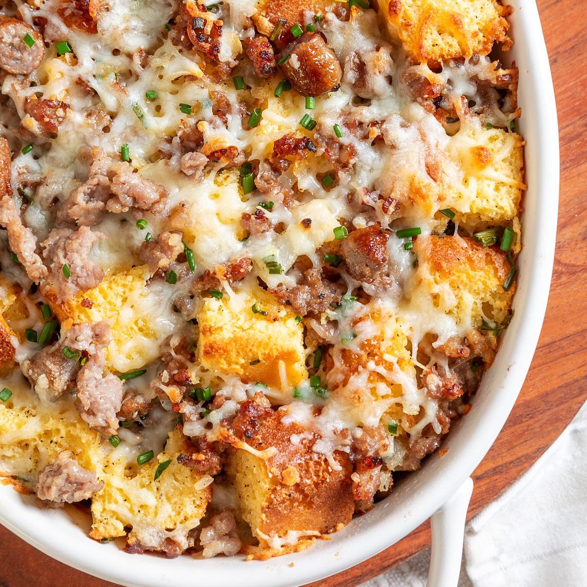 Leftover cornbread breakfast casserole with maple sausage, eggs, melted cheese and chives