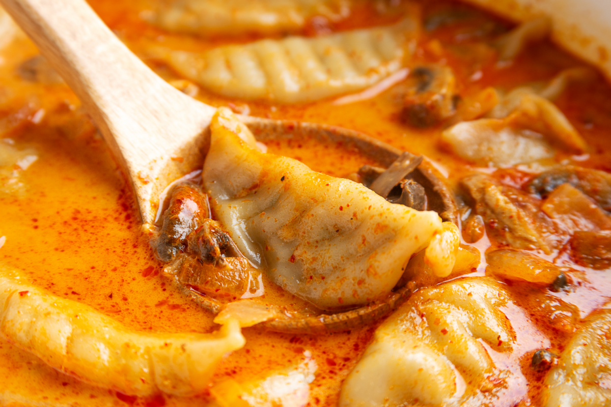 Frozen Pork Potstickers in Thai Coconut Curry Soup Pork potstickers and sliced mushrooms simmering in the orange coconut red curry broth.