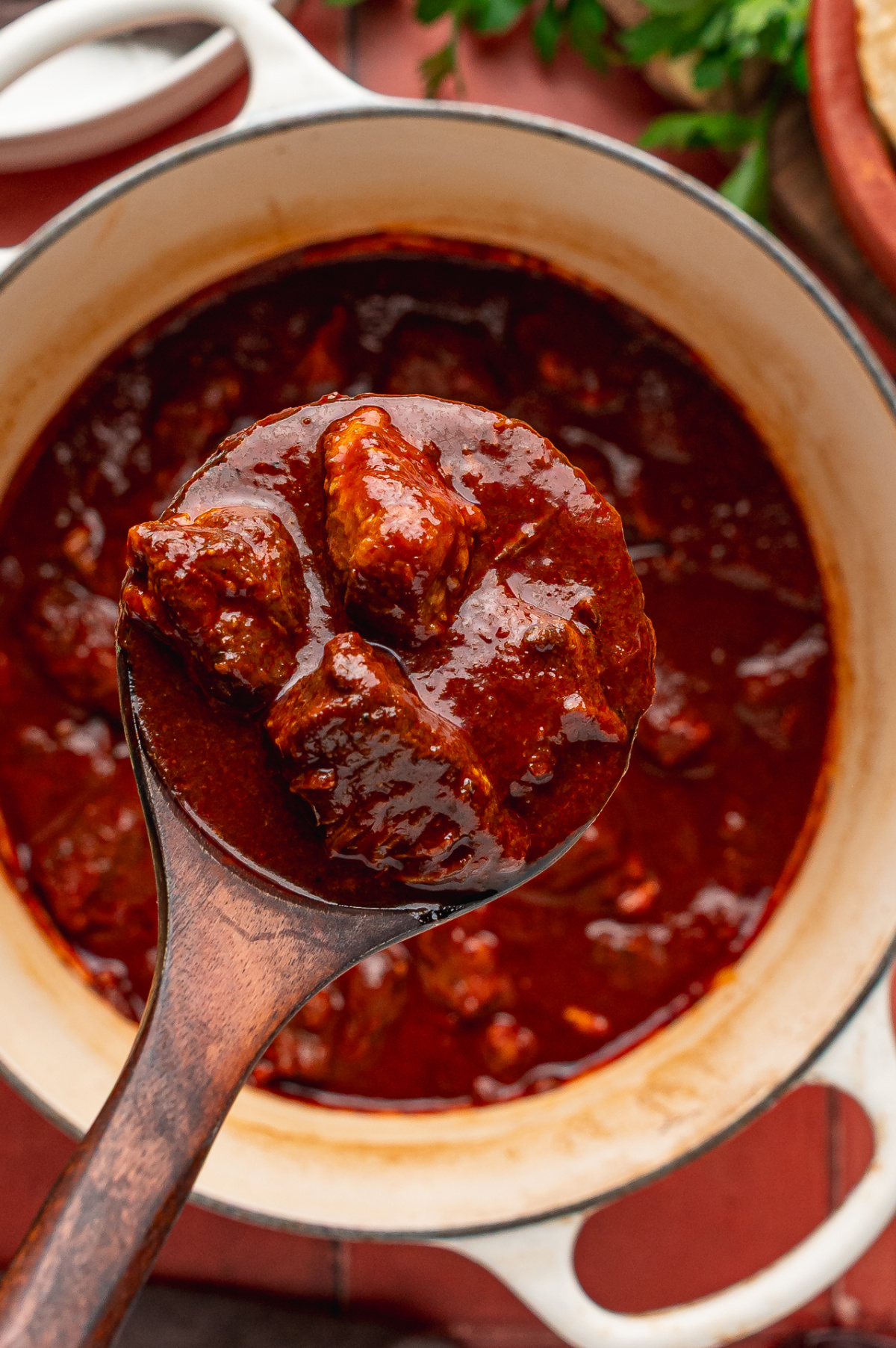 Tender pieces of pork shoulder in the finished red chile sauce
