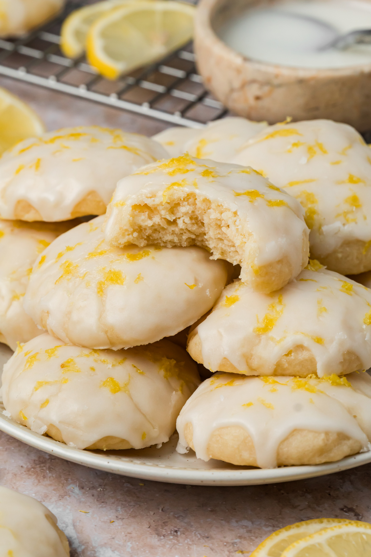 Soft Ricotta Cookies with Lemon Glaze Soft ricotta cookies with lemon glaze and fresh zest with one cookie broken open to show the center
