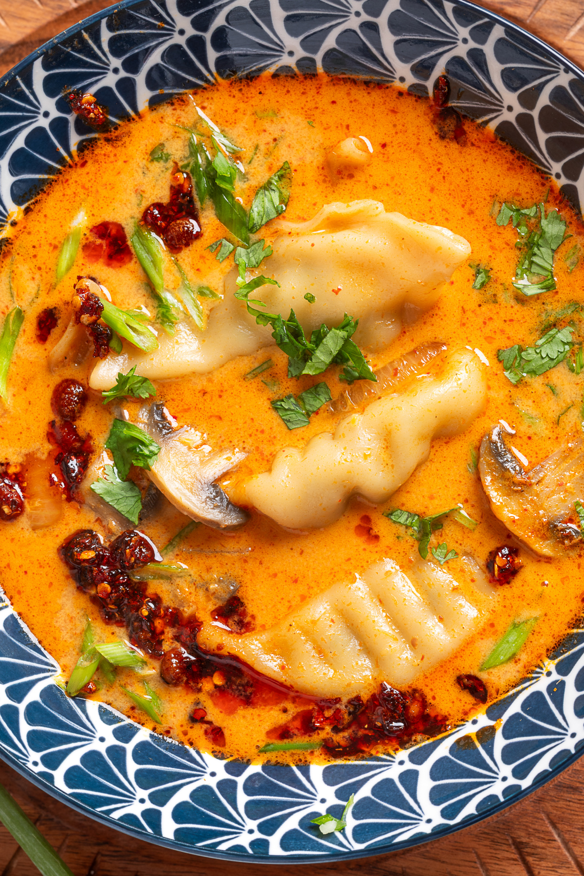 Thai Dumpling Soup with Frozen Pork Potstickers Thai Dumpling Soup with pork potstickers, mushrooms, and chili crisp in a creamy coconut red curry broth.
